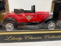 Side profile of red and black Liberty Classics Model A Hot Rod diecast car with Canadian Tire logo in original box.