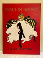 Full view of painting showing seated Can Can dancer on bright red background with text "MOULIN ROUGE MUSEE GREVIN".