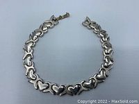 Photo of the sterling silver heart design link bracelet laid out flat showing heart-shaped links and clasp.