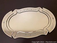 Full view of the Venetian style mirror vanity tray showing its shape, floral etching, and raised edges.