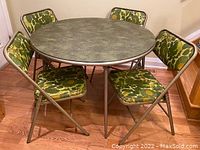 Full set of vintage Samsonite folding card table with four matching chairs, arranged in a room on wood floor.