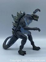 Side view of the posable Godzilla figure showing detailing on tail, body and raised arm.