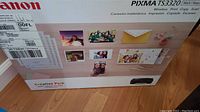 Front of the Canon PIXMA TS3320 printer box displaying product features and promotional images.