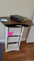 Photo of lap desk with soft bottom, ESV Study Bible on top, and white wooden organizer with wicker baskets below.