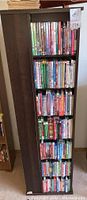 Photo of tall DVD shelf with various DVDs including holiday and other movies
