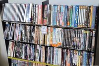 Two shelves of assorted DVD cases on bookcase