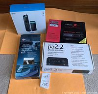 Group shot of all four boxed items on orange mat.