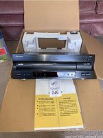 Front view of player in open box showing disc tray and display