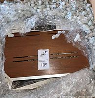 Top view of wood-grain cabinet surrounded by packing peanuts and bubble wrap