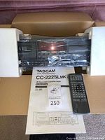 Unboxed unit in foam packaging with remote, cables and manual