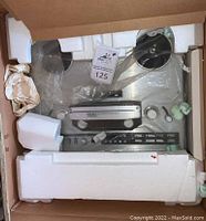Top-down view of TEAC X-1000 in styrofoam packaging inside original box