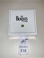 Front view of sealed white box packaging with “The Beatles In Mono” and green apple logo