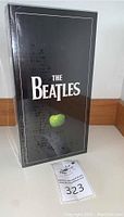 Box set upright showing front with The Beatles logo and green apple image.