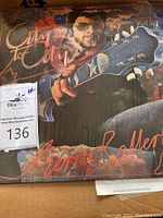 Front cover of Gerry Rafferty 'City to City' vinyl album showing illustration of a man with guitar and stylized text.