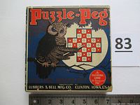 Square cardboard box with owl illustration and Puzzle Peg title, showing vintage design and manufacturer information.