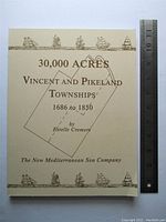 Front cover of the paperback book showing the title, author, and decorative sailing ship illustrations with a transparent overlay ruler for scale.