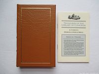 Front view of the leather-bound book alongside its informational booklet.