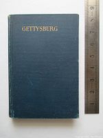Front cover shows blue cloth binding with gilt title 'Gettysburg' and ruler for size reference
