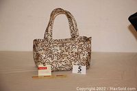 Full view of the colorful Harveys seatbelt bag with two handles and original tag displayed in front.