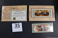 Photo showing colorized $1 bill on cardboard with Certificate of Authenticity.
