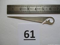 Sterling silver letter opener measured against a steel ruler showing length of 6.25 inches with catalog number 61 below.