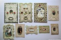 Group photo of nine Victorian lace paper cards with love and floral themes, arranged in two rows on a white background