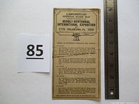 Front of official guide map showing text and title with ruler for size comparison and lot number card.