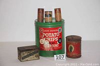 Photo showing all six vintage tins including three spice tins, cigar tin, tobacco tin, and large potato chip tin arranged with a lot number card