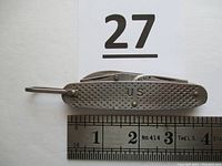 Top view of steel folding utility knife closed with ruler showing length approximately 3.5 inches, featuring textured grip and 'U.S.' stamp.