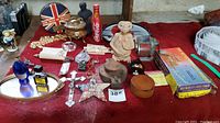 Photo showing assorted vintage collectibles including E.T. pull string toy, metal tray, small decorative pieces, Coca-Cola bottle.