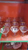 Twelve coupe glasses arranged in rows showing size and condition.