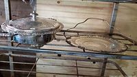 Two items side by side on metal rack: silver-tone Marlboro caddy tray with handle on the right, Glasbake casserole with lid on the left