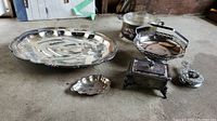 All items in lot including silverplate tray, trinket box, tea strainer and Glasbake casserole dish.