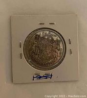 Obverse of the coin showing the crowned shield with lion and unicorn, inscribed 'Canada 1947' and '50 Cents'.