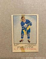 Front of the vintage hockey card showing Bill Juzda in Toronto Maple Leafs uniform with statistics and text.