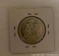 Reverse side showing detailed crowned coat of arms of Canada on a silver 50 cent coin from 1964.