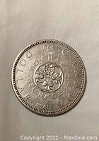 Reverse side of the 1964 Canadian Silver Dollar coin showing the floral emblems and inscriptions.