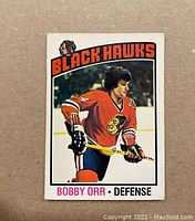Front view of vintage 1976-77 O-Pee-Chee Bobby Orr Black Hawks hockey trading card #213 showing image and team logo.