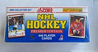 Front and sides of a sealed blue box containing the 1990 Score NHL Hockey Premier Edition 445 player cards set, showing branding and promotional images of hockey players including Eric Lindros.