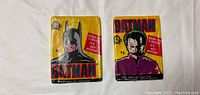 Front view of two sealed Batman trading card packs from 1989 featuring Batman and Joker artwork on the packaging.