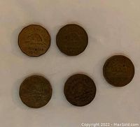 Five 1942 Canadian 5-cent coins showing the beaver design on the reverse side, made of tombac alloy with visible wear and patina.