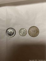Three Canadian silver coins from the 1960s showing animal designs and slight wear.