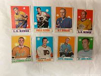 Front side of eight 1970-71 O-Pee-Chee hockey cards featuring players in uniform against solid color backgrounds.