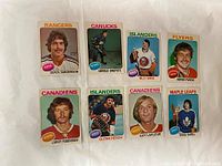 Front of eight 1975-76 O-Pee-Chee hockey cards showing player portraits from various NHL teams.