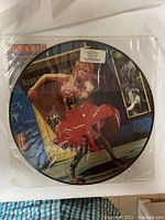 Vinyl record featuring Cyndi Lauper dancing in a red dress, labelled with album details.