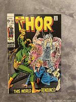 Front cover image of The Mighty Thor #167 featuring Thor and Loki with a man in a blue suit.