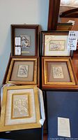 Full view of all five framed embossed silver pictures, showing different frames and embossed designs