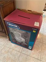 Closed box of Invacare raised toilet seat with arms, showing front and side panel with product image and details.