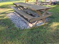 Side angle showing entire 12ft picnic table with attached benches and supporting frame.