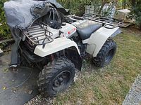 Front-left three-quarter view showing front rack, headlight, left front fender and tire.